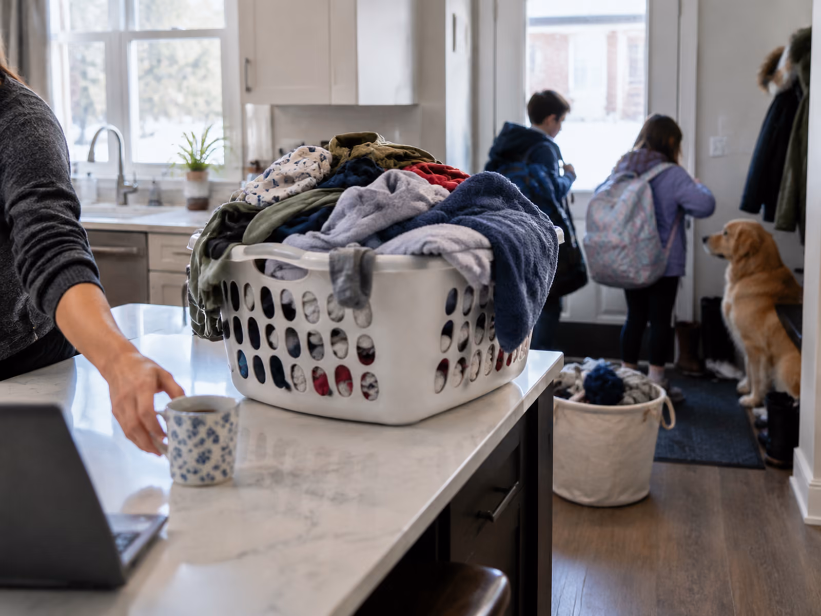 A busy Ottawa family kitchen with a laundry basket and kids in the background