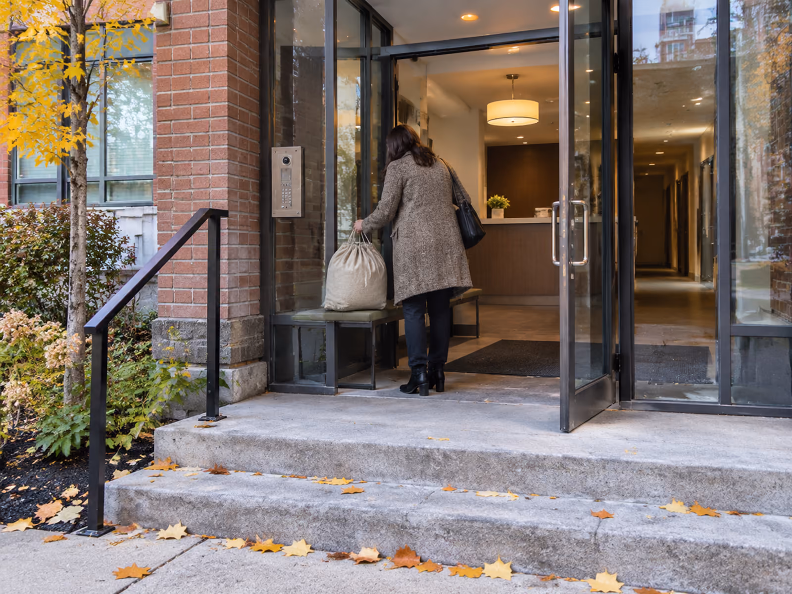 A modern Ottawa condo building entrance where laundry pickup bags are collected