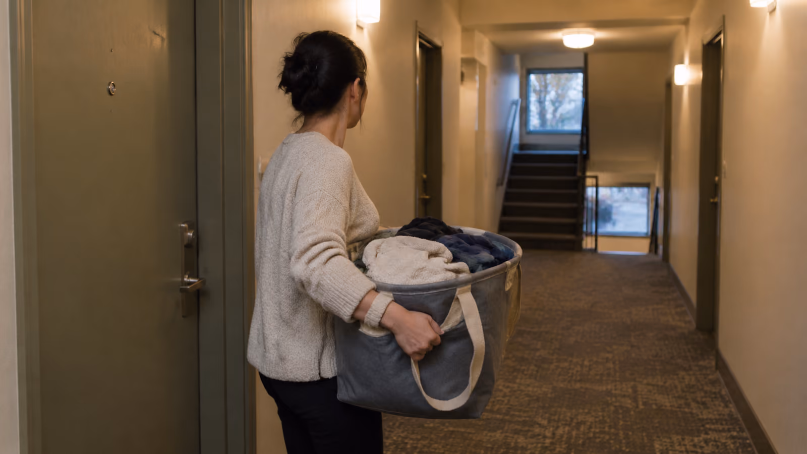 A downtown Ottawa apartment hallway weighing laundry options without an in-suite washer