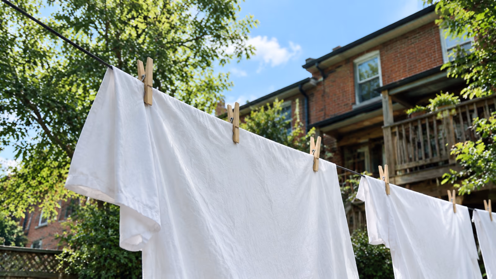 Soft white sheets drying in natural light reflecting fragrance-free laundry care