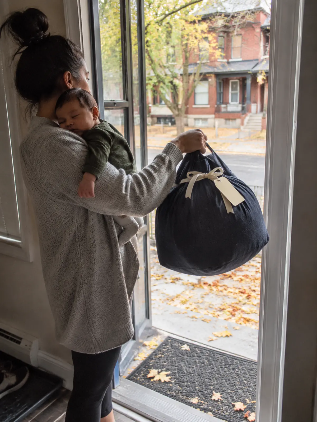 A family in a bright kitchen, the kind of moment a laundry gift card protects.